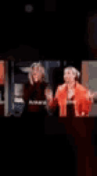 a blurry picture of a woman in an orange dress in a living room