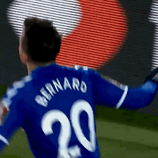 a soccer player wearing a blue jersey with the number 20 on it