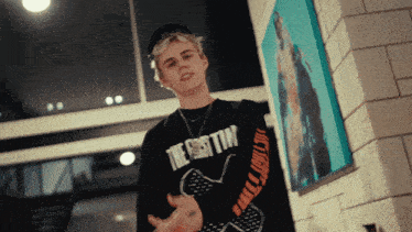 a boy wearing a black shirt that says the position