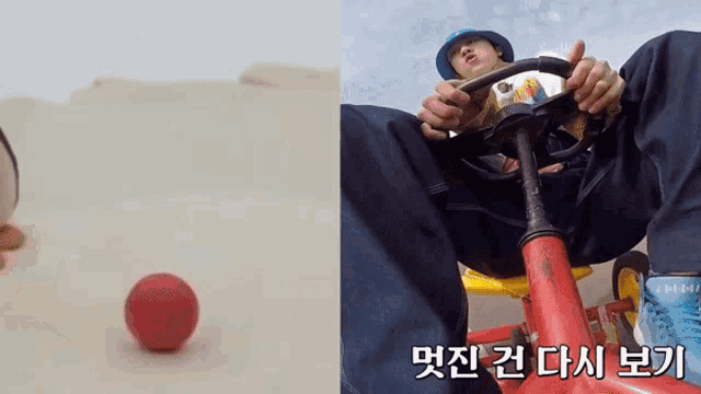 a man is sitting on a red bike next to a red ball with korean writing on it