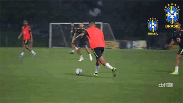a group of soccer players are playing on a field with the word brasil on the top