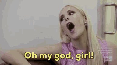 a woman in a pink dress is sitting on a couch and says `` oh my god , girl ! ''