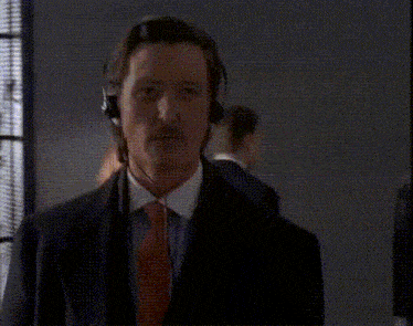 a man in a suit and tie with headphones on his head