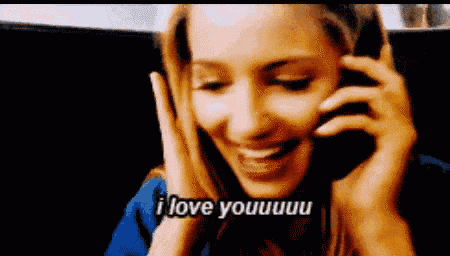 a woman is talking on a cell phone and saying i love you .