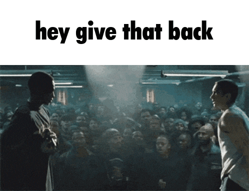 two men standing in front of a crowd with the text hey give that back