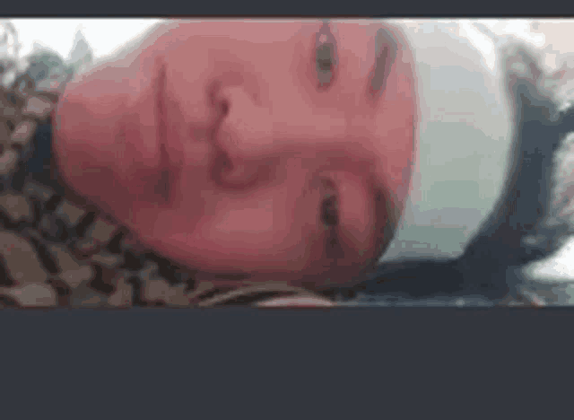 a woman with a bandage on her head is laying down .