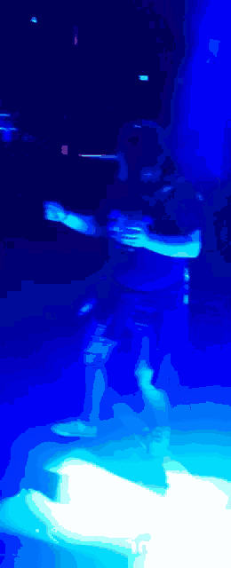 a blurry picture of a person dancing in a dark room