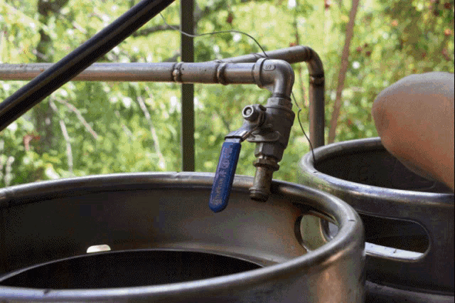 a blue valve that says ' stainless steel ' is attached to a pipe