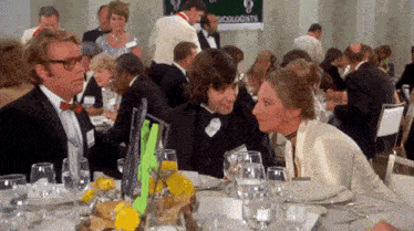 a group of people sitting at a table with a sign that says ' psychologists '