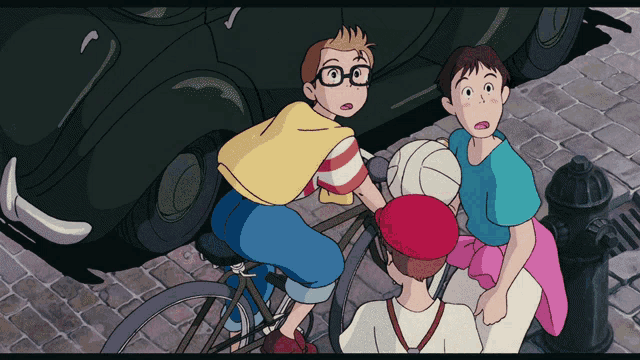 a boy with glasses is riding a bike next to two other boys