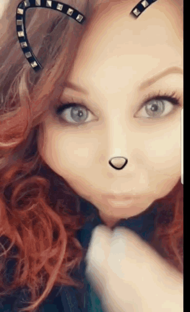 a close up of a woman 's face wearing cat ears