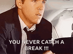 a man in a suit and tie is sitting in a car and saying `` you never catch a break ! ''
