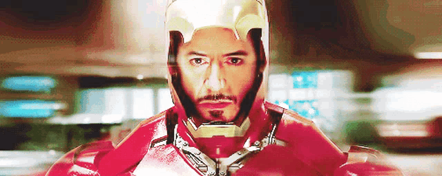 a man with a beard wearing a helmet and a red suit