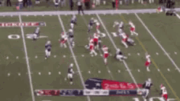 a football game is being played on a field with the letter c in the middle of the field