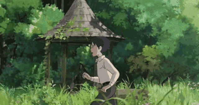 a young boy is running through a grassy field in front of a gazebo .