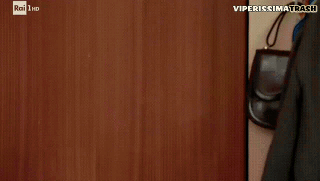 a man is standing in front of a door that says rai