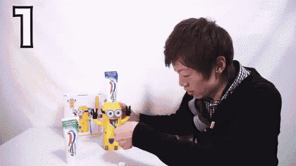 a man is putting toothpaste into a toothpaste dispenser with the number 1 on it
