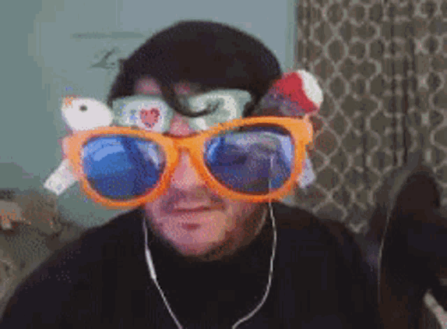 a man wearing a pair of sunglasses with a stuffed animal on the lenses .