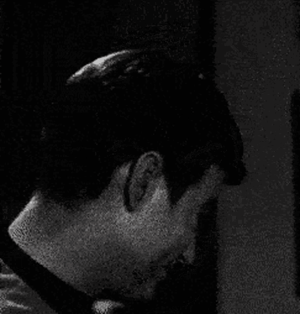 a close up of a man 's face in a black and white photo