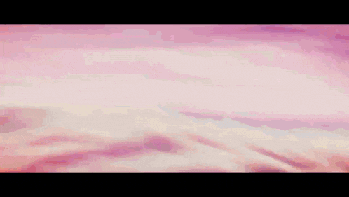 a person is flying through the air with a pink background .