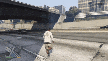 a man wearing a white hoodie that says ' r.s. ' on it is walking down a street