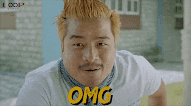 a man wearing a white shirt that says omg