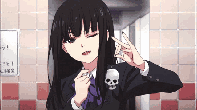 a girl in a school uniform with a skull keychain making a peace sign