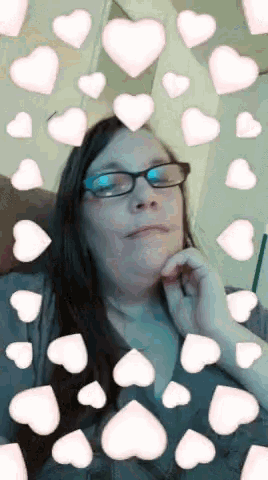 a woman with glasses is surrounded by hearts