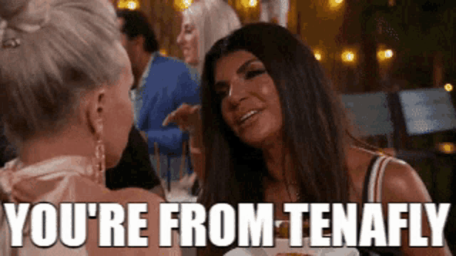 two women are talking to each other and one of them is saying `` you 're from tenafly ''