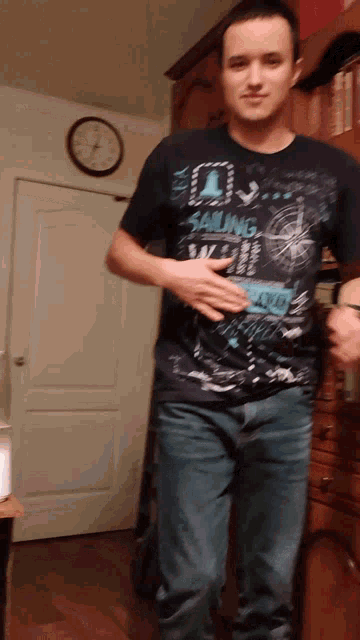 a man is wearing a shirt that says sailing