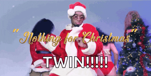 a man in a santa suit is dancing in front of a christmas tree with the words " nothing for christmas twin !!! "