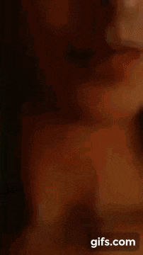 a close up of a woman 's face with her eyes closed and lipstick on her lips .