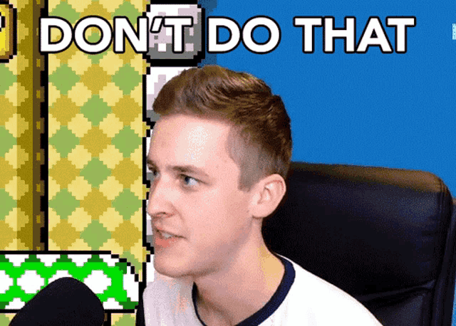 a man sitting in front of a screen that says " don t do that "