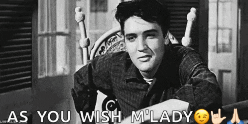 elvis presley is sitting in a chair in a black and white photo with the words `` as you wish m lady '' above him .