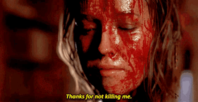 a bloody woman says thanks for not killing me