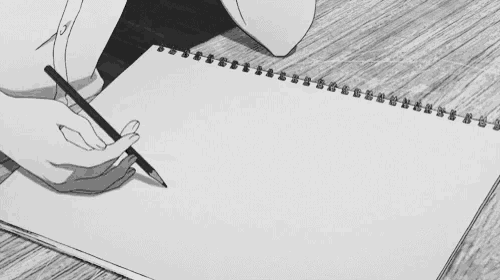 a person is writing in a notebook with a pencil on a wooden table .
