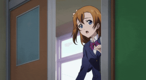 a girl with brown hair and blue eyes stands in a doorway
