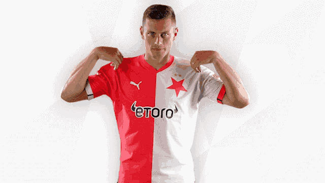 a man wearing a red and white jersey with etoro on it