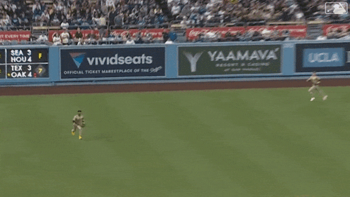 a baseball game is underway with a vividseats ad on the wall