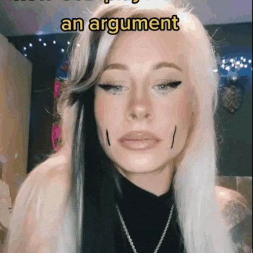 a woman with a black and white hair style has an argument written on her face