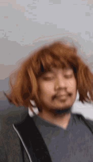 a man with a beard and red hair is wearing a wig