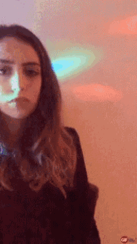 a woman 's face is shown in a blurry photo with the word gif below her