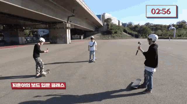 a man is taking a picture of a group of skateboarders with a timer that reads 02:56