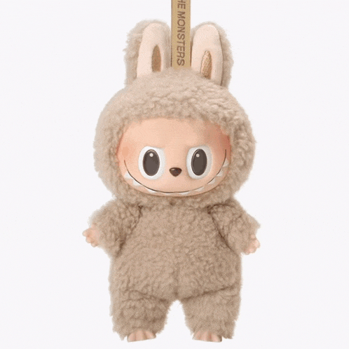 a stuffed animal with a man 's face on it has the word monsters on it