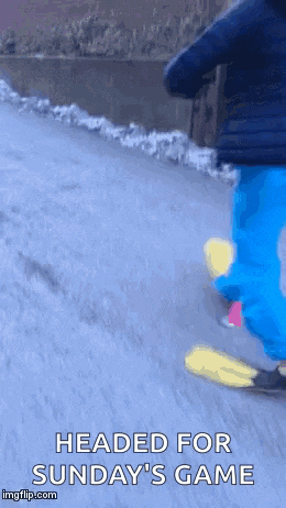 a person is riding a skateboard down a road with the words headed for sunday 's game below them