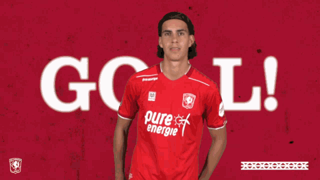 a man in a red pure energie shirt stands in front of a red background