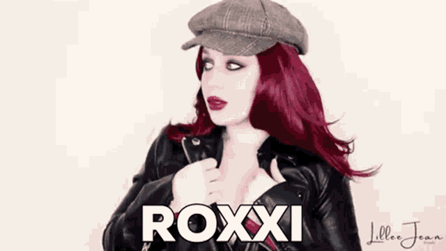 a woman with red hair and a hat is wearing a leather jacket and a hat .