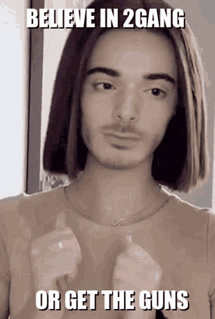 a man with long hair and a beard is giving a thumbs up and says believe in 2 gang or get the guns .