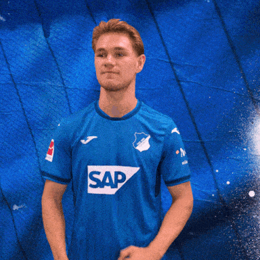 a man wearing a blue shirt that says sap