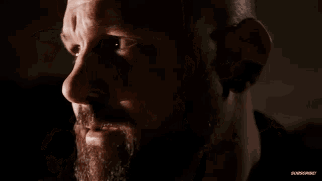 a close up of a man 's face with the words " subscribe " on the bottom right